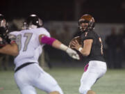 Battle Ground&#039;s Gunner Talkington, right, looks for an open teammate while under pressure in the second quarter at Battle Ground High School on Friday night, Oct. 7, 2016.