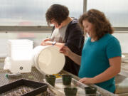 Woodland: Woodland Middle School eighth-graders Olivia-Hart, from left, and Hope Davis in their horticulture class, where teacher Joseph Bosch is teaching the students hydroponic planting for the first time, so they can grow vegetables without soil.