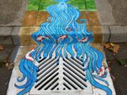 Arnada: Mother-daughter duo Racheal Stahlman and Sabra Morin teamed up to paint a goddess as part of the Vancouver Watersheds Alliance effort to raise awareness about what storm drains do by having local artists paint them.