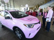 Don Stose, the legislative liaison for the Pink Lemonade Project, right, and Jeanne Firstenburg, former president of the Pink Lemonade Project, admire a pink Toyota RAV4 on Friday at McCord&#039;s Vancouver Toyota. McCord&#039;s donated the SUV to the Vancouver nonprofit. Markon Brand Design wrapped the vehicle in pink and the nonprofit&#039;s logos.