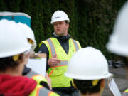 Robinson Construction Project Manager Bryan Kenney, center, talks to Hockinson Middle School students before a tour of the construction site of the future middle school.