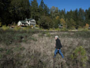 Al Greenwood walks through what used to be the bottom of Northwestern Lake along the White Salmon River. Five years after the breach, cabin owners are still adjusting to life without the lake.