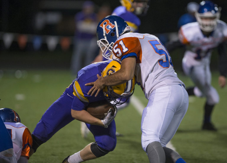 Columbia River&#039;s Nathan Kunz (7) runs out of room against Ridgefield defender Noah Honokaupu (51) in the third quarter at Kiggins Bowl on Thursday night, Oct. 27, 2016.