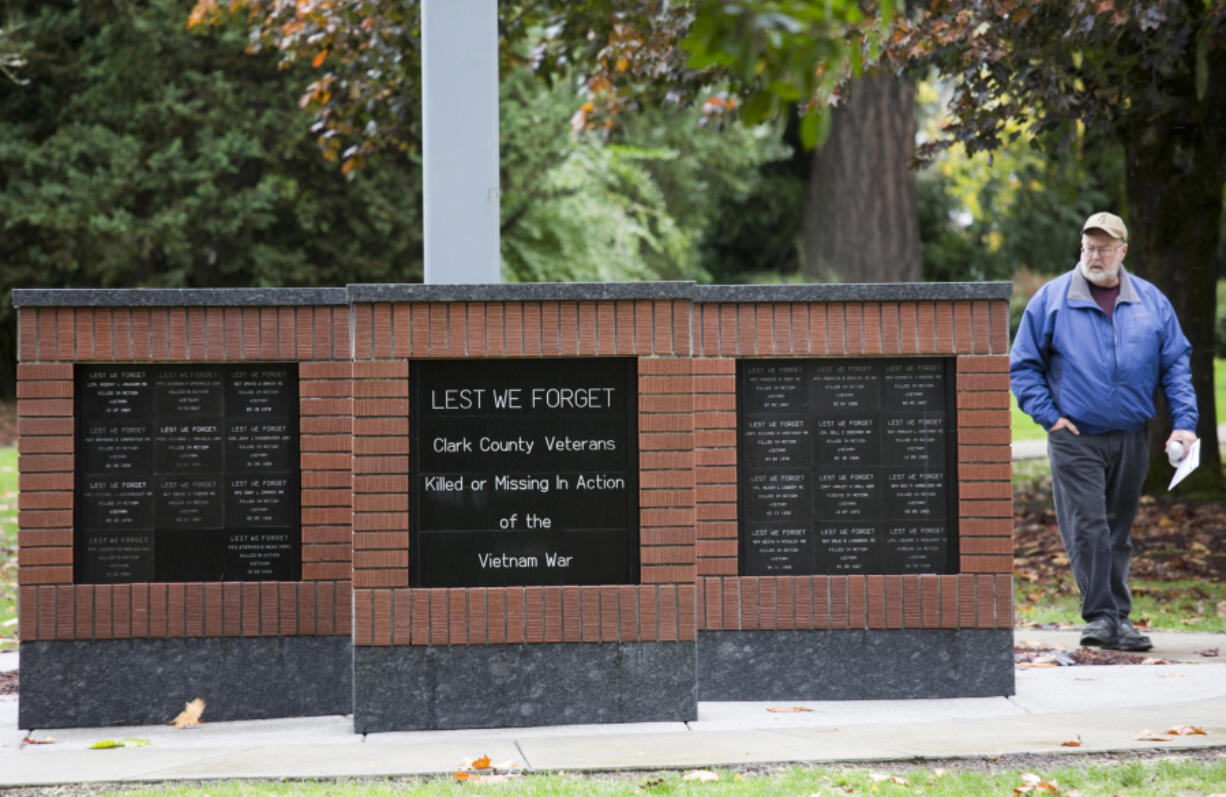 Gary Matthiessen walks past a new memorial bearing the names of 58 Clark County men who were killed in Vietnam; it was dedicated Saturday.