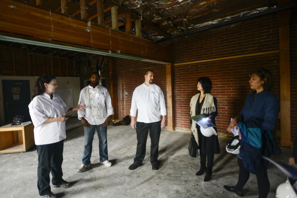 Clark College Cuisine Instructor Aaron Guerra, center, talks Thursday to interested wine and beer distributors about Clark College&#039;s new culinary program during a tour of the facility that&#039;s under construction, aiming to open next fall.