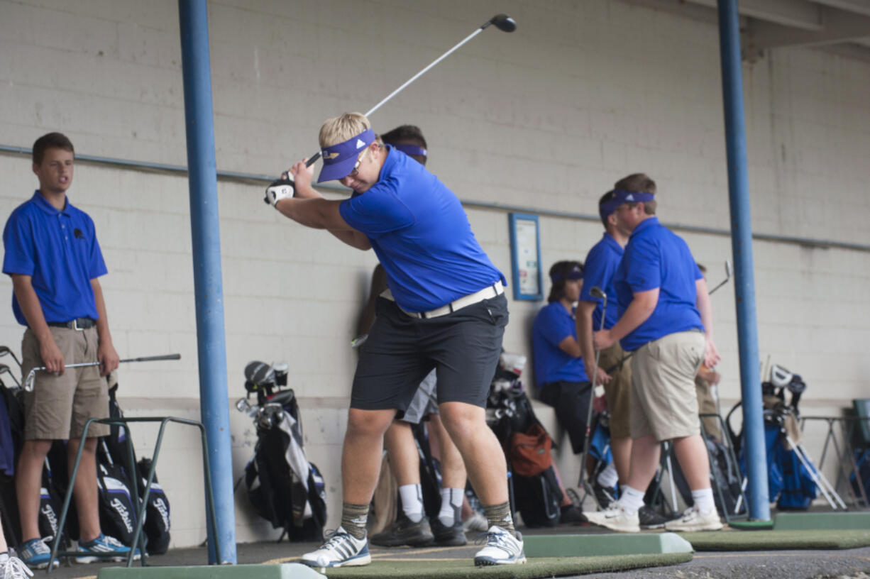 Columbia River Golfer Spencer Long, center, practices at Tri Mountain Golf Course in Ridgefield, Thursday September 29, 2016.