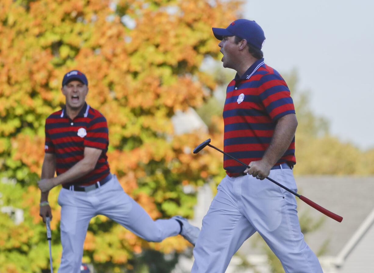 United States’ Patrick Reed celebrates his birdie on the 14th hole with United States’ Jordan Spieth during a four-ball match at the Ryder Cup golf tournament Saturday, Oct. 1, 2016, at Hazeltine National Golf Club in Chaska, Minn.