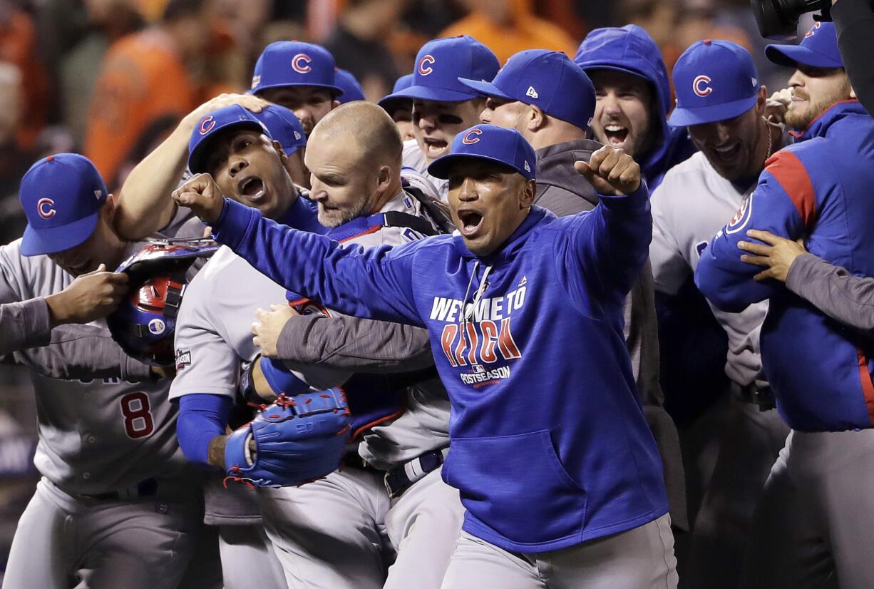 Chicago Cubs pitcher Aroldis Chapman, second from left, catcher David Ross, third from left, and teammates celebrate after Game 4 of baseball's National League Division Series against the San Francisco Giants in San Francisco, Tuesday, Oct. 11, 2016. The Cubs won 6-5.