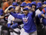 Chicago Cubs pitcher Aroldis Chapman, second from left, catcher David Ross, third from left, and teammates celebrate after Game 4 of baseball's National League Division Series against the San Francisco Giants in San Francisco, Tuesday, Oct. 11, 2016. The Cubs won 6-5.