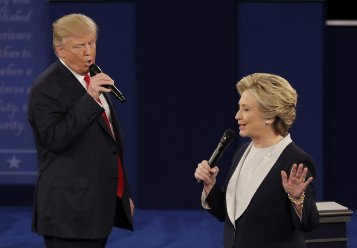 Republican presidential nominee Donald Trump and Democratic presidential nominee Hillary Clinton speak during the second presidential debate Sunday at Washington University in St. Louis.