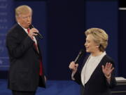 Republican presidential nominee Donald Trump and Democratic presidential nominee Hillary Clinton speak during the second presidential debate Sunday at Washington University in St. Louis.