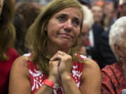 Rochelle Pasquariello of Leighton, Pa., watches as Republican presidential candidate Donald Trump speaks at a campaign rally Friday in Newtown, Pa.