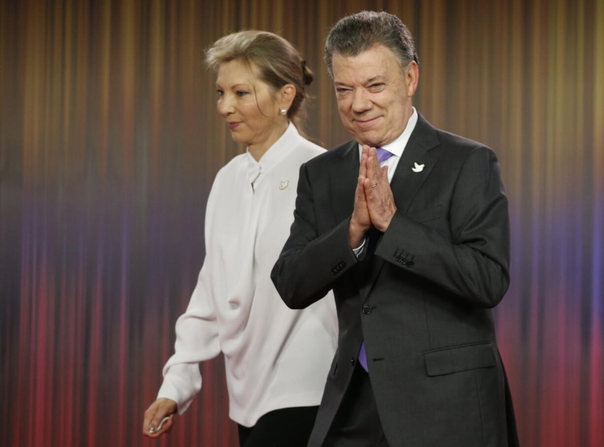 Colombia&#039;s President Juan Manuel Santos, right, arrives with his wife Maria Clemencia Rodirguez for a press conference at the presidential palace in Bogota, Colombia, Friday, Oct. 7, 2016.  Colombian President Juan Manuel Santos won the Nobel Peace Prize Friday, just days after voters narrowly rejected a peace deal he signed with rebels of the Revolutionary Armed Forces of Colombia, FARC.