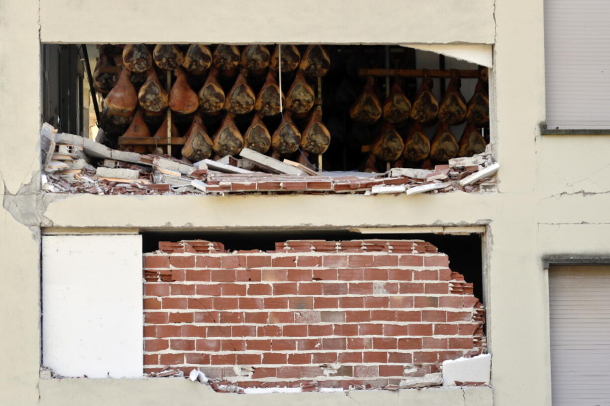 Cured hams are seen through a heavily damaged warehouse in Norcia, central Italy, Monday, Oct. 31, 2016. The third powerful earthquake to hit Italy in two months spared human life Sunday but struck at the nation&#039;s identity, destroying a Benedictine cathedral, a medieval tower and other beloved landmarks that had survived the earlier jolts across a mountainous region of small historic towns.