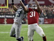 Seattle Seahawks free safety Earl Thomas (29) breaks up a pass intended for Arizona Cardinals running back David Johnson (31) during the first half of a football game, Sunday, Oct. 23, 2016, in Glendale, Ariz.