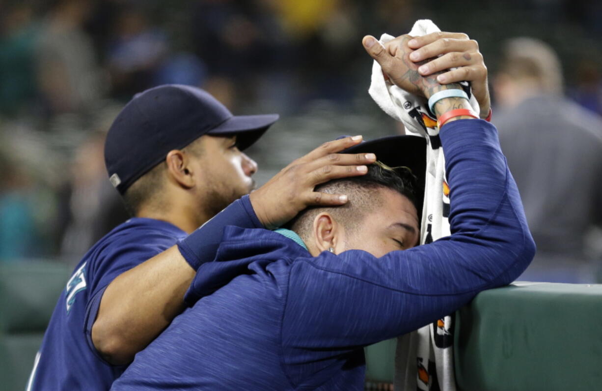 Seattle Mariners&#039; Franklin Gutierrez, left, consoles pitcher Felix Hernandez, right, after the Oakland Athletics defeated the Mariners 9-8 in 10 innings in a baseball game, Saturday, Oct. 1, 2016, in Seattle. (AP Photo/Ted S.