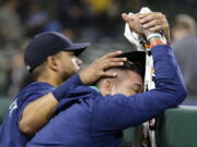 Seattle Mariners&#039; Franklin Gutierrez, left, consoles pitcher Felix Hernandez, right, after the Oakland Athletics defeated the Mariners 9-8 in 10 innings in a baseball game, Saturday, Oct. 1, 2016, in Seattle. (AP Photo/Ted S.