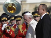 Pope Francis and Azerbaijan&#039;s President Ilham Aliyev, foreground right, review of the honor guard on the occasion of their meeting at the presidential palace Sunday in Baku, Azerbaijan. Francis traveled to Azerbaijan on Sunday for a 10-hour visit aimed at encouraging the country&#039;s inter-religious harmony while likely overlooking criticism of a referendum that extends the president&#039;s term and powers.