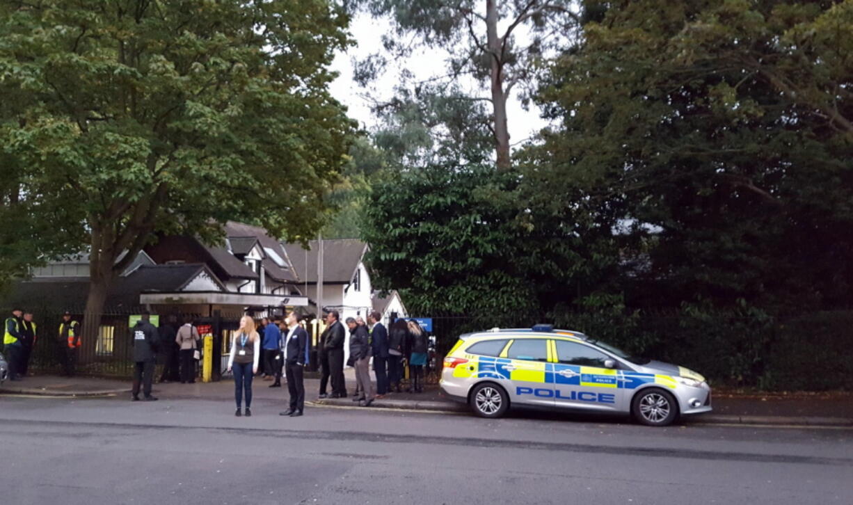 Police and evacuated visitors stand outside London Zoo after a gorilla escaped in London, Thursday, Oct. 13, 2016. London police say an incident involving a gorilla that escaped from its enclosure at the London Zoon has been concluded. There are reports the animal was subdued Thursday with a tranquilizer gun and recaptured. There were no initial reports of injuries.