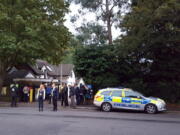 Police and evacuated visitors stand outside London Zoo after a gorilla escaped in London, Thursday, Oct. 13, 2016. London police say an incident involving a gorilla that escaped from its enclosure at the London Zoon has been concluded. There are reports the animal was subdued Thursday with a tranquilizer gun and recaptured. There were no initial reports of injuries.