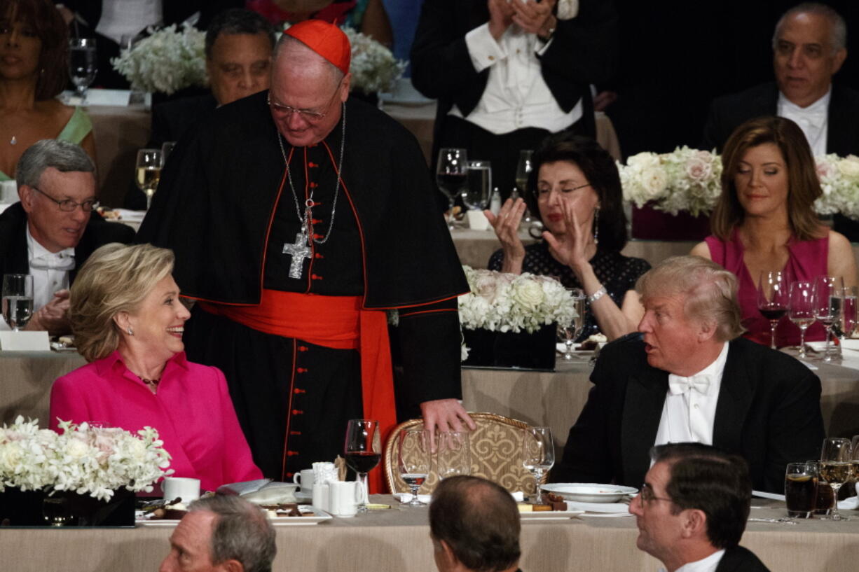 Donald Trump, right, talks with Hillary Clinton and Cardinal Timothy Dolan, cardinal of New York, center, Thursday during the Alfred E. Smith Memorial Foundation dinner.