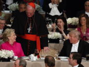 Donald Trump, right, talks with Hillary Clinton and Cardinal Timothy Dolan, cardinal of New York, center, Thursday during the Alfred E. Smith Memorial Foundation dinner.