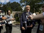 In this photo taken Oct. 5, 2016, Hillary Clinton's campaign manager John Podesta speaks to members of the media outside Democratic presidential candidate Hillary Clinton's home in Washington. Hacked emails show Hillary ClintonÄôs campaign wrestled with how to announce her opposition to construction of the controversial Keystone XL pipeline without losing the support of labor unions that supported to project. Emails published this week by WikiLeaks show debate and confusion within the Clinton camp as it faced down the unexpectedly strong primary challenge by liberal Sen. Bernie Sanders, who opposed the pipeline.