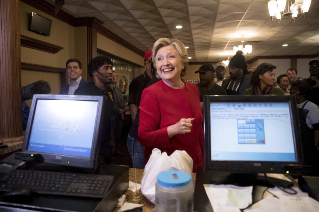 Democratic presidential candidate Hillary Clinton smiles as she speaks with an employee of Angie&#039;s Soul Cafe in Cleveland on Monday.