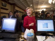 Democratic presidential candidate Hillary Clinton smiles as she speaks with an employee of Angie&#039;s Soul Cafe in Cleveland on Monday.