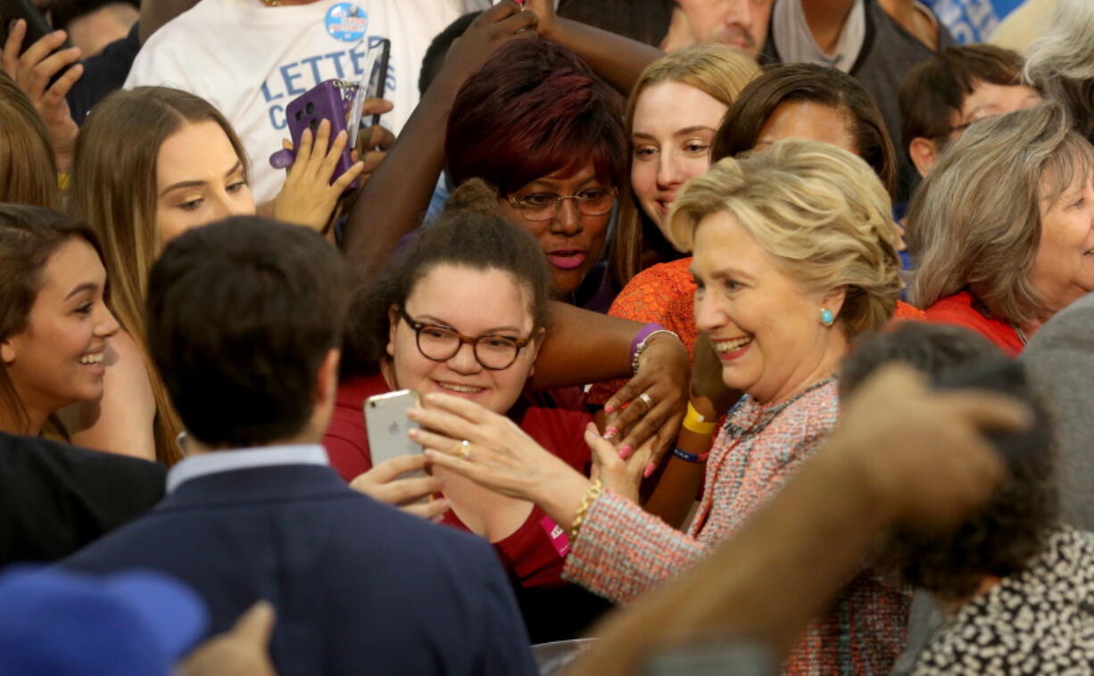 Democratic presidential candidate Hillary Clinton poses for photos after speaking at a rally at Miami Dade College in Miami on Tuesday.