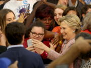 Democratic presidential candidate Hillary Clinton poses for photos after speaking at a rally at Miami Dade College in Miami on Tuesday.