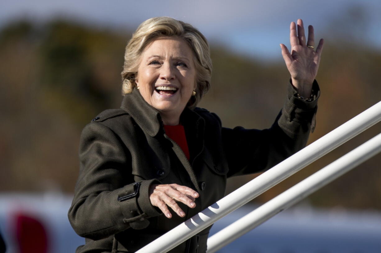 Democratic presidential candidate Hillary Clinton waves to members of the media as she boards her campaign plane at Westchester County Airport in White Plains, N.Y., on Monday to travel to Cleveland for a rally.