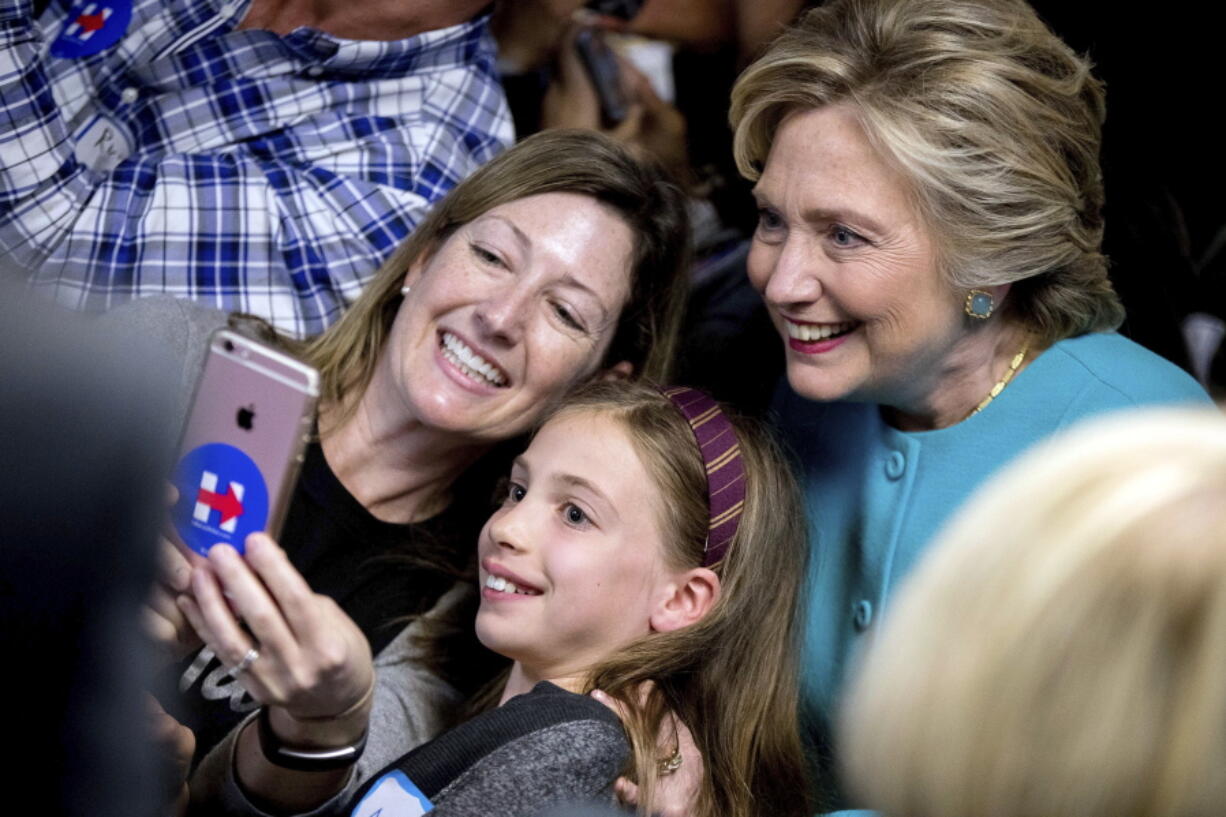 Democratic presidential candidate Hillary Clinton takes a photograph with supporters at a campaign office in Seattle on Friday.