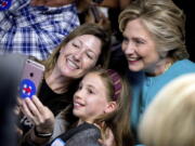 Democratic presidential candidate Hillary Clinton takes a photograph with supporters at a campaign office in Seattle on Friday.