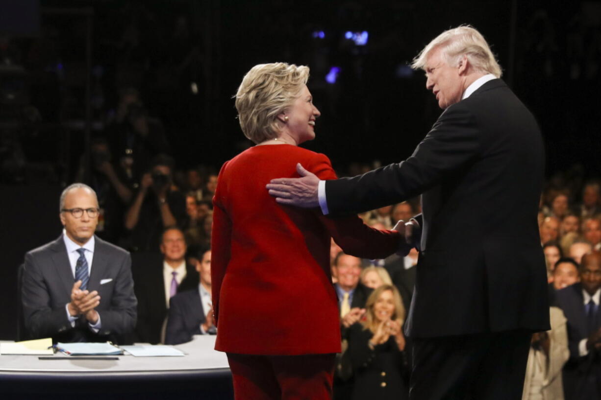 Democratic presidential nominee Hillary Clinton and Republican presidential nominee Donald Trump shake hands during the presidential debate at Hofstra University in Hempstead, N.Y.