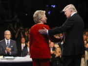 Democratic presidential nominee Hillary Clinton and Republican presidential nominee Donald Trump shake hands during the presidential debate at Hofstra University in Hempstead, N.Y.