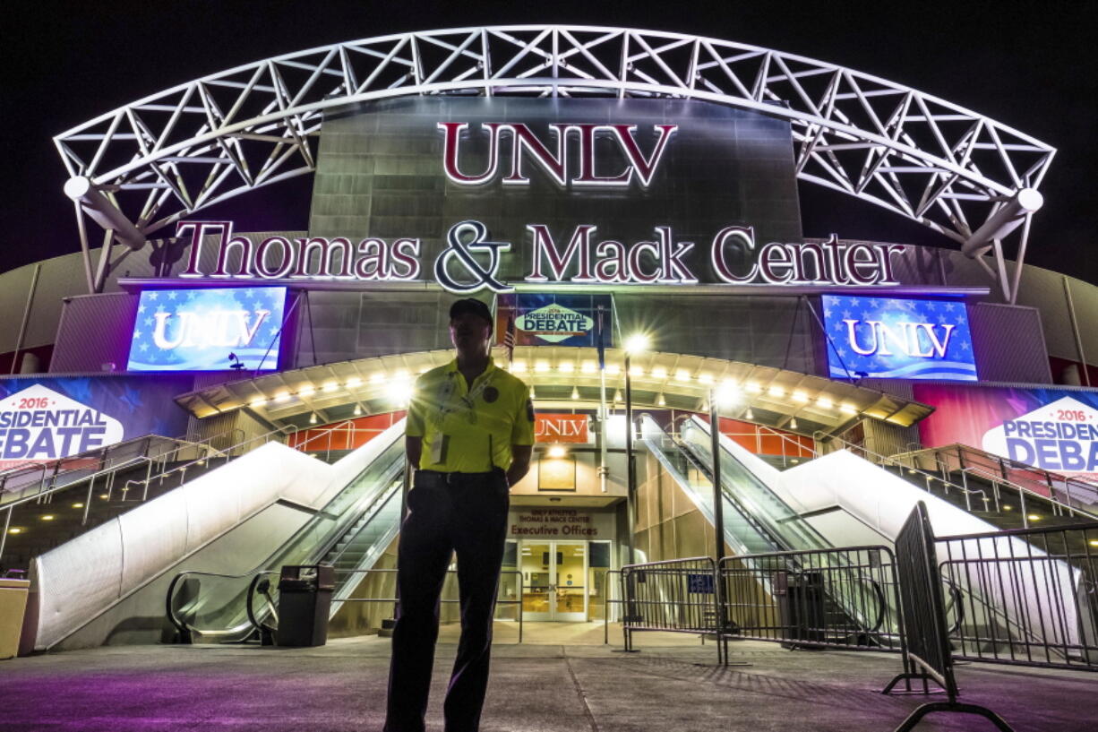 A member of the security team stands in front of the presidential debate site at the University of Nevada, Las Vegas in Las Vegas late Sunday. Democratic presidential nominee Hillary Clinton and Republican presidential nominee Donald Trump will meet in their third and final debate on Wednesday. (AP Photo/J.