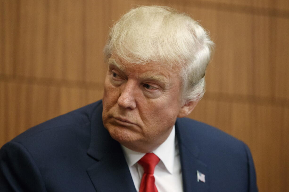 Republican presidential candidate Donald Trump looks on as Juanita Broaddrick speaks before the second presidential debate with Democratic presidential candidate Hillary Clinton at Washington University on Sunday.