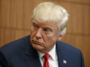 Republican presidential candidate Donald Trump looks on as Juanita Broaddrick speaks before the second presidential debate with Democratic presidential candidate Hillary Clinton at Washington University on Sunday.