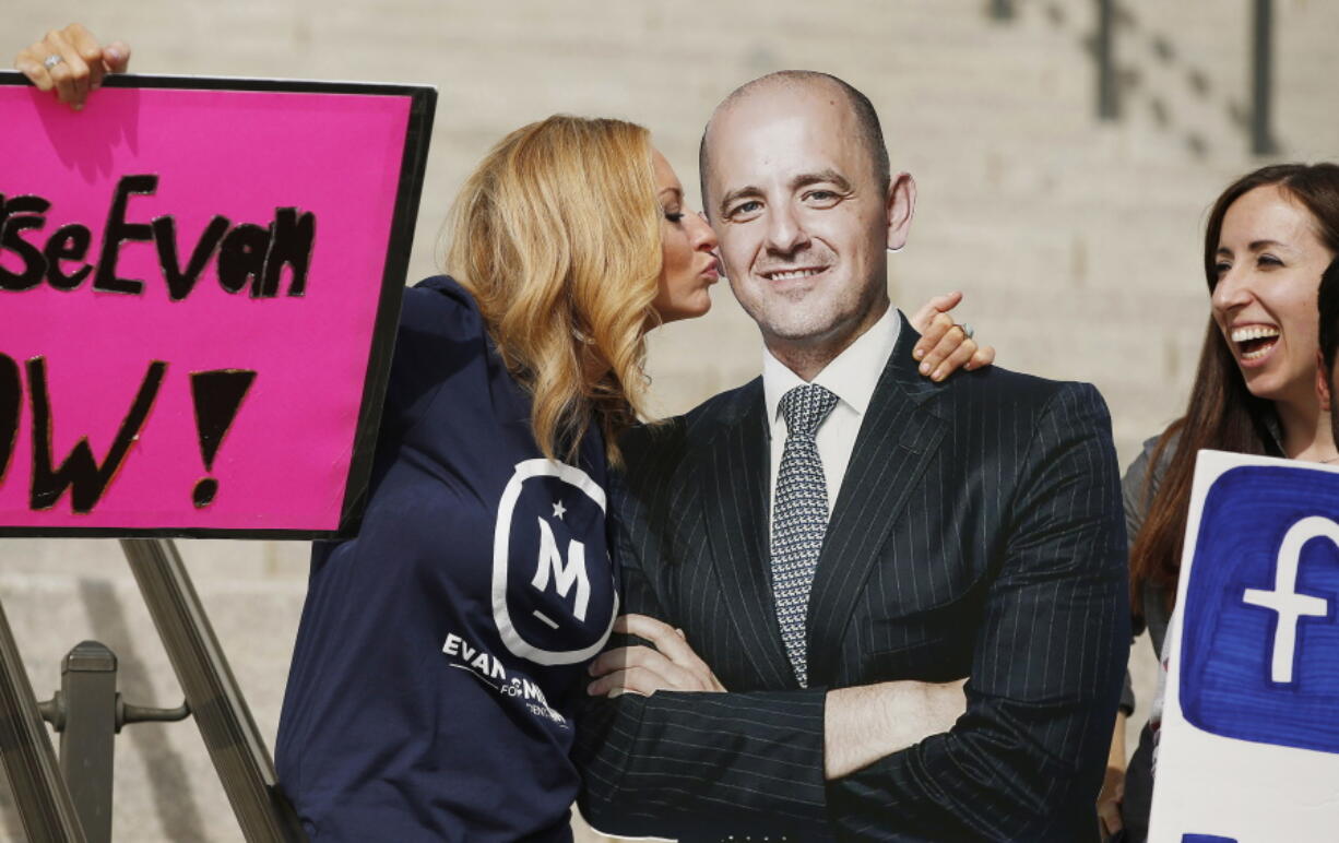 Brynnley Pyne pretends to kiss a cardboard cutout of Evan McMullin as McMullin supporters rally at the Utah State Capitol in Salt Lake City.  (Jeffrey D.