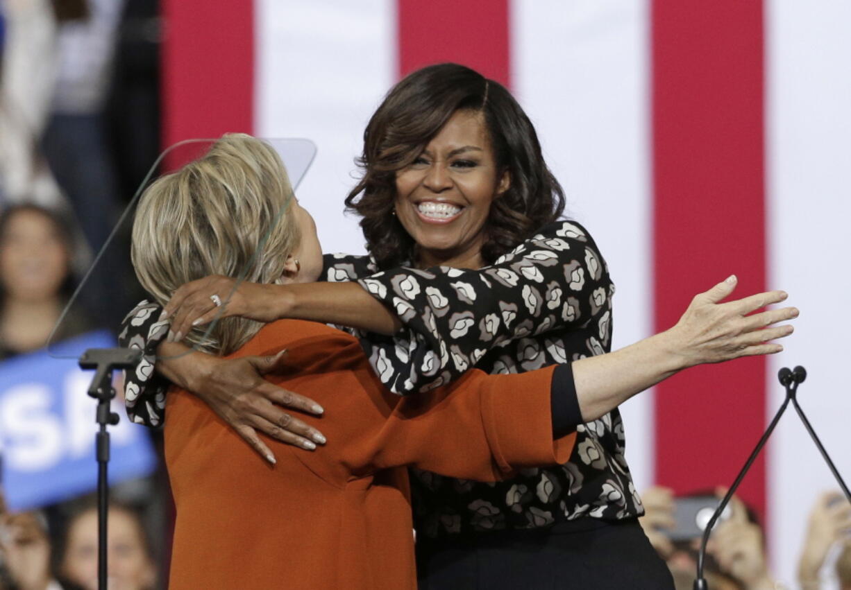 Democratic presidential candidate Hillary Clinton and first lady Michelle Obama hug during a campaign rally in Winston-Salem, N.C., Thursday, Oct. 27, 2016.