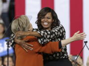 Democratic presidential candidate Hillary Clinton and first lady Michelle Obama hug during a campaign rally in Winston-Salem, N.C., Thursday, Oct. 27, 2016.