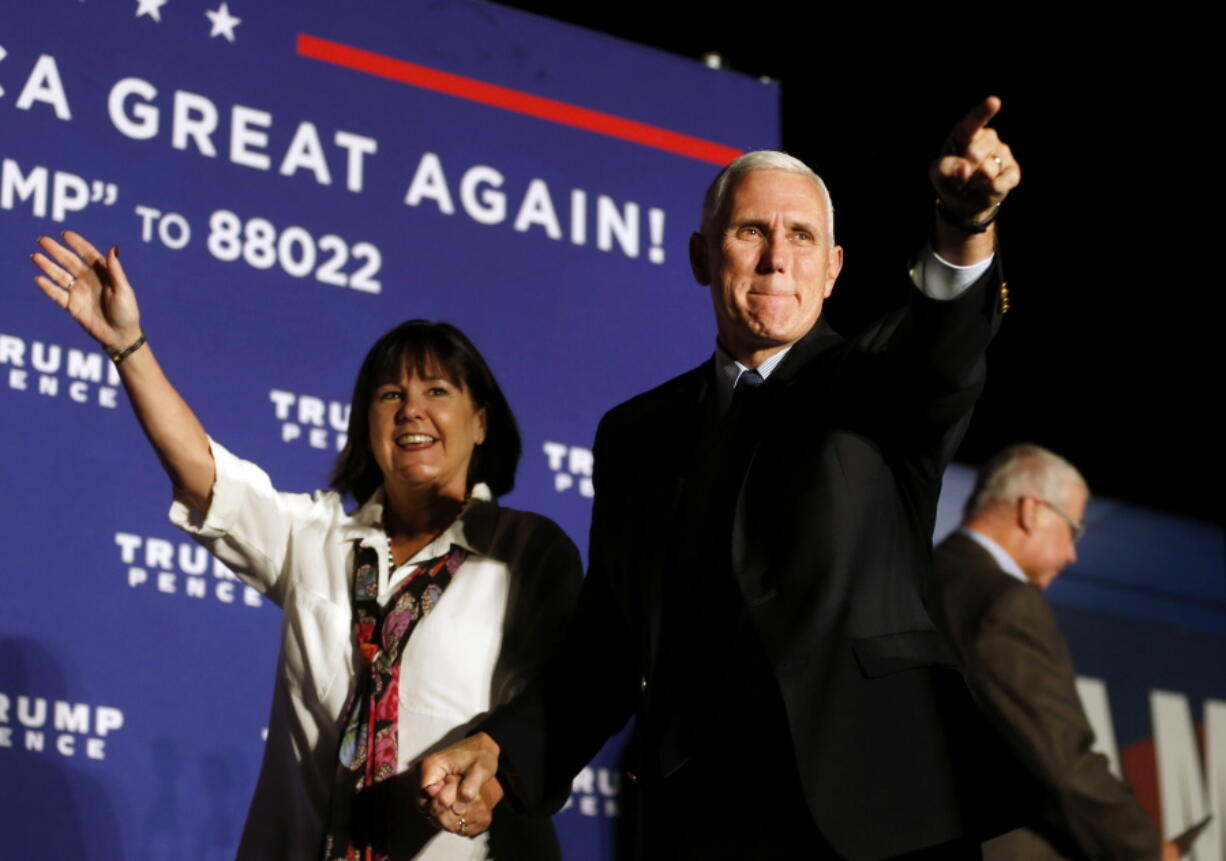 Republican vice presidential nominee Indiana Gov. Mike Pence, arrives with his wife, Karen, at a campaign rally at Cox Transportation Services in Ashland, Va., Monday Oct. 3, 2016.