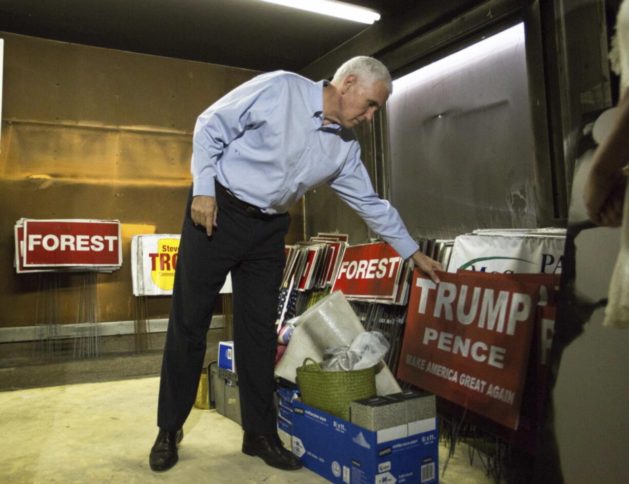 Republican vice presidential candidate, Indiana Gov. Mike Pence inspects the damage inside the Orange County Republican Party Headquarters in Hillsborough, N.C., on Tuesday. The office was firebombed overnight during the previous weekend.