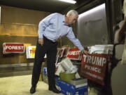 Republican vice presidential candidate, Indiana Gov. Mike Pence inspects the damage inside the Orange County Republican Party Headquarters in Hillsborough, N.C., on Tuesday. The office was firebombed overnight during the previous weekend.