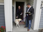 Sen. Mark Mullet, D-Issaquah, right, talks to a voter as he rings doorbells with his dog Arthur in Issaquah, Wash. Mullet is being challenged for his seat in the state legislature by State Rep. Chad Magendanz, R-Issaquah. (AP Photo/Ted S.