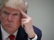 Republican presidential candidate Donald Trump listens to a speaker during a meeting with Cuban supporters at Trump National Doral on Tuesday in Miami.