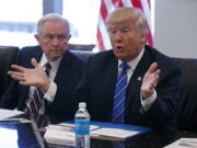 Sen. Jeff Sessions, R-Ala., left, looks on Friday as Republican presidential candidate Donald Trump speaks during a national security meeting with advisers at Trump Tower in New York.