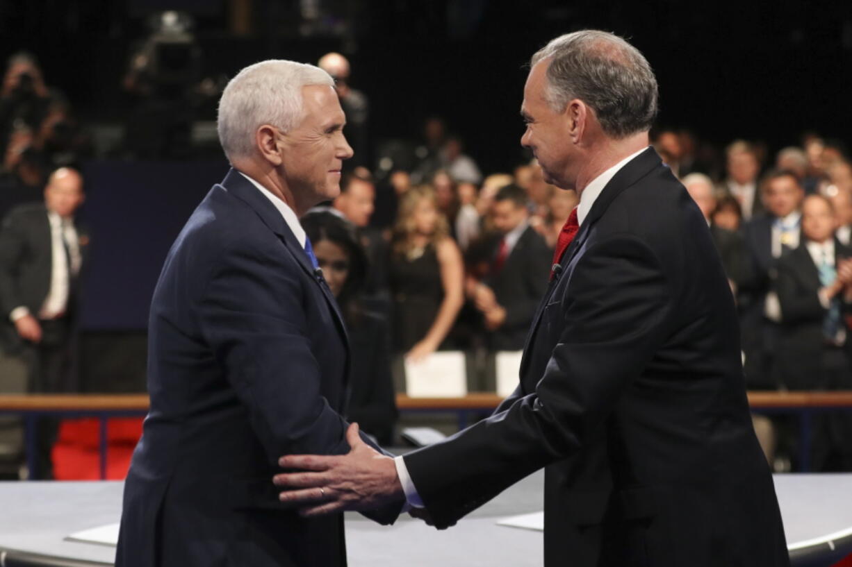 Republican vice-presidential nominee Gov. Mike Pence and Democratic vice-presidential nominee Sen. Tim Kaine shake hands after the vice-presidential debate at Longwood University in Farmville, Va., on Tuesday.