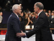 Republican vice-presidential nominee Gov. Mike Pence and Democratic vice-presidential nominee Sen. Tim Kaine shake hands after the vice-presidential debate at Longwood University in Farmville, Va., on Tuesday.